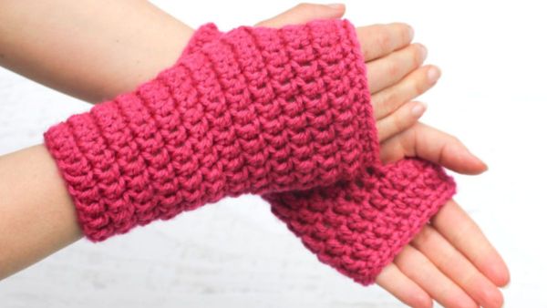 a person wearing crochet fingerless gloves