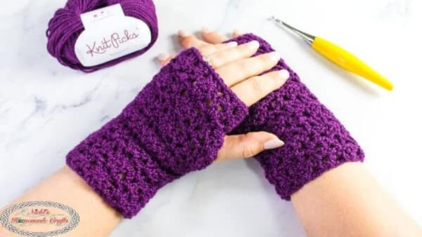 a woman wearing lacy fingerless gloves