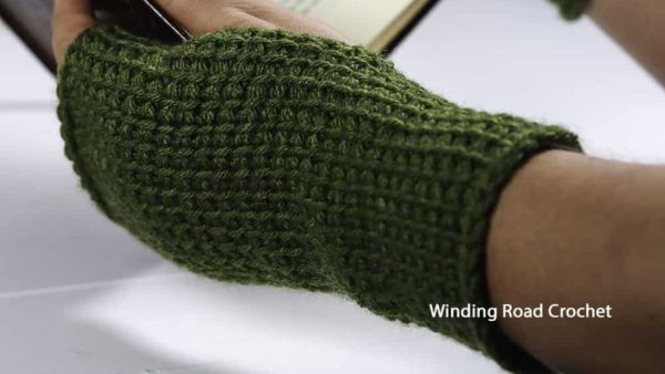 a person wearing tunisian crochet wrist warmer