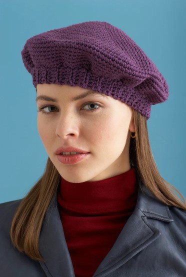 A woman wearing the Le Chic Crochet Beret