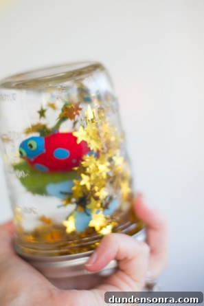 Madeline’s Colorful DIY Flower-Filled Birthday Party Ideas 23 Glitter Critter Jar Favors