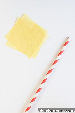 A stripped straw and yellow paper