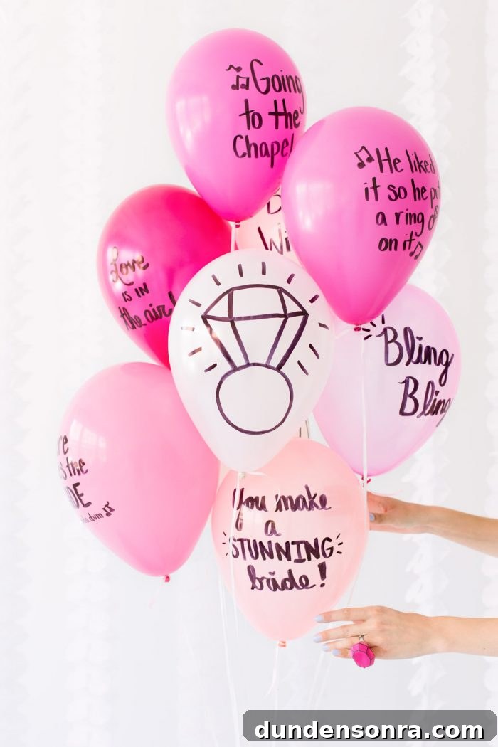Pink balloons with words on them written in sharpie. 