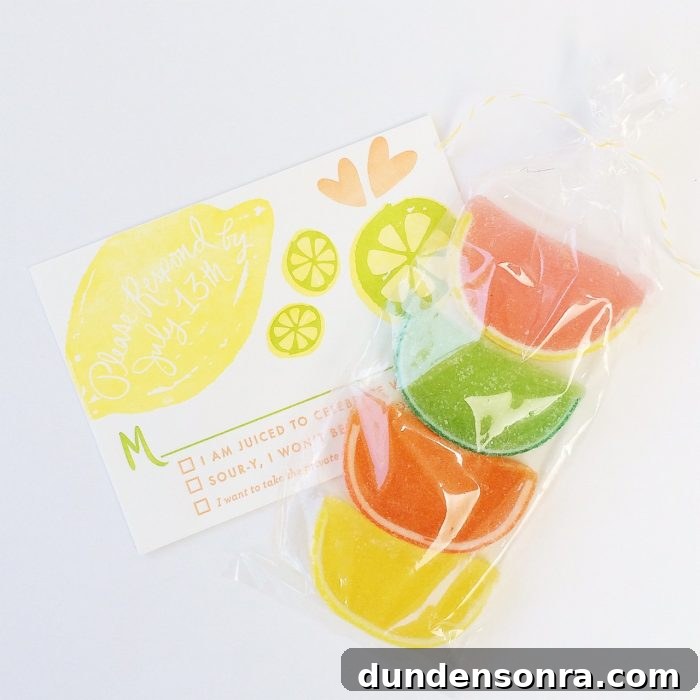 Clear bag with citrus gummies in it next to an invitation to a bridal shower. 