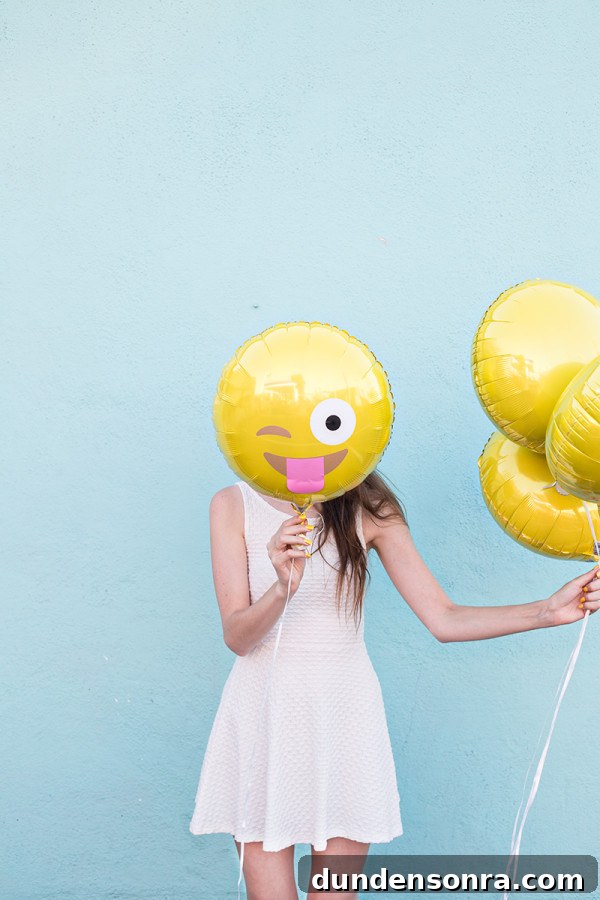 How to Make Emoji Balloons at Home: Fun DIY Guide 3 A woman standing next to a body of water