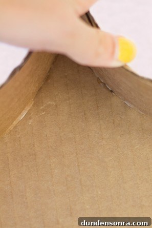 Someone making a cardboard craft 