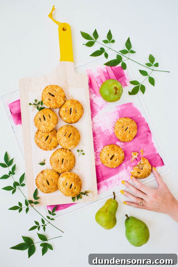 Vanilla Cardamom Pear Hand Pies — Homemade Mini Dessert Pies 15 Mini pies on a cutting board