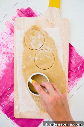 Someone cutting dough into circles 