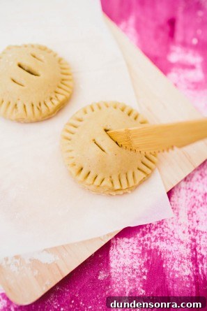 Vanilla Cardamom Pear Hand Pies — Homemade Mini Dessert Pies 10 Someone making mini pies
