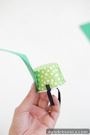 green leaf being glued on paper cup