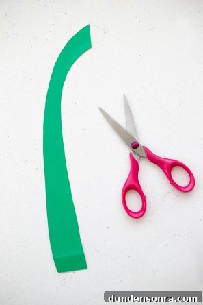 green paper stem with scissors next to it