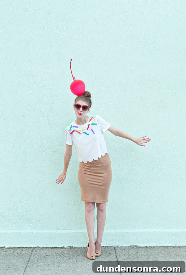 A woman dressed as ice cream in front of a blue wall