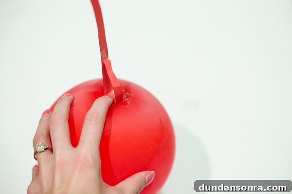 Someone holding a fake cherry 