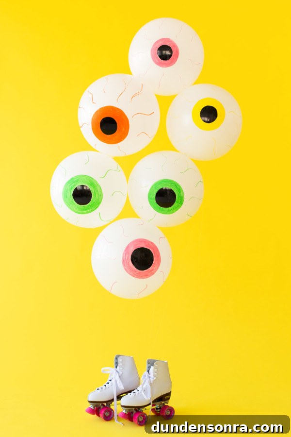 How to Make Spooky Eyeball Balloons for Halloween Decorations 4 Eyeball balloons in front of a yellow wall