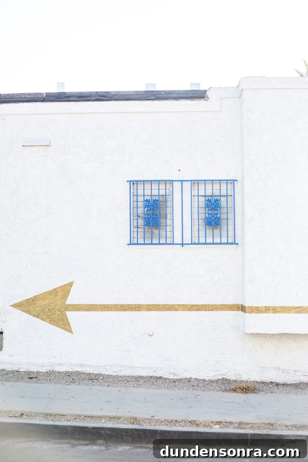 A gold arrow on a white building 