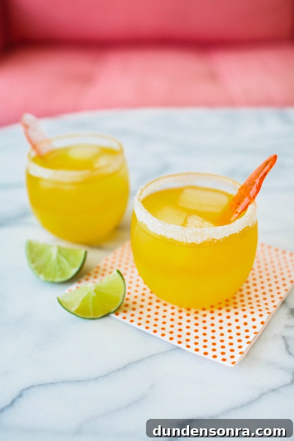 Cups with orange drink and limes next to it