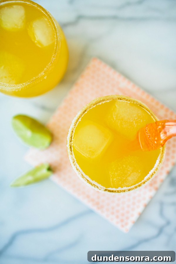 A cup with an orange liquid 