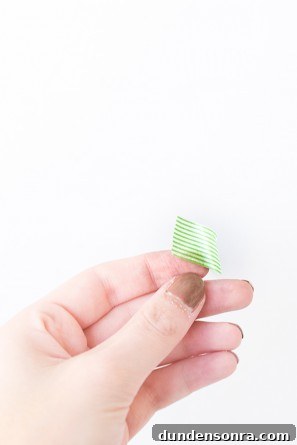 Someone holding green tape 