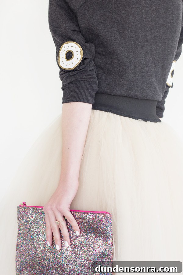DIY Donut Elbow Patches: How to Sew Cute Patch Repairs 11 The back of someone wearing a sweater and skirt and holding a clutch
