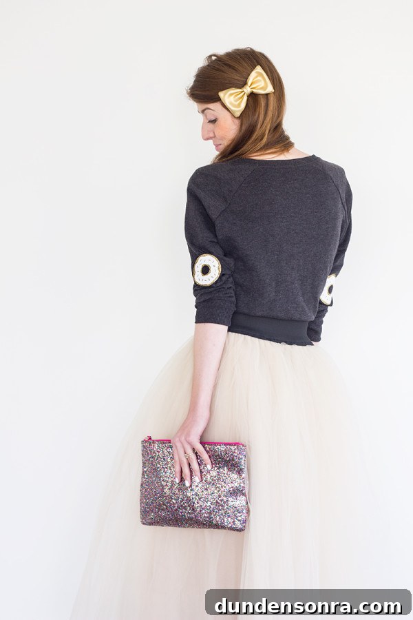 DIY Donut Elbow Patches: How to Sew Cute Patch Repairs 3 The back of someone wearing a sweater and skirt and holding a clutch