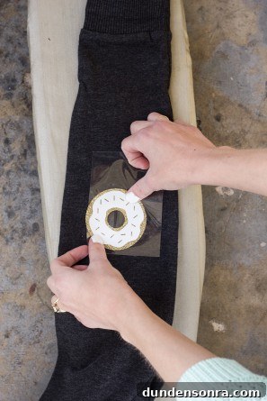 DIY Donut Elbow Patches: How to Sew Cute Patch Repairs 9 Someone putting a donut patch on a sweater