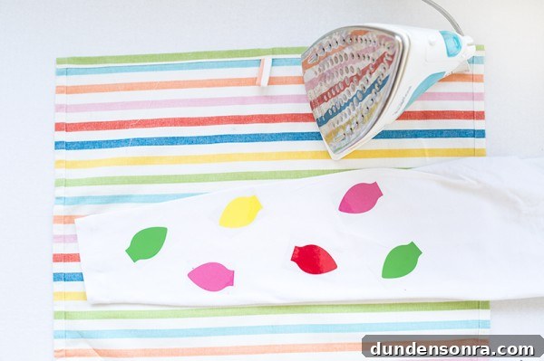 DIY Christmas Light Leggings: Make Festive LED Holiday Leggings 5 Someone ironing colorful patches on leggings