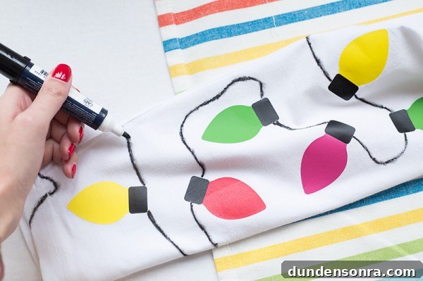 DIY Christmas Light Leggings: Make Festive LED Holiday Leggings 7 Someone drawing Christmas lights on leggings