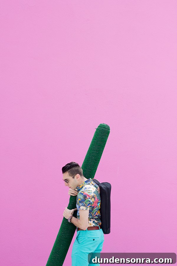 A man in front of a pink wall