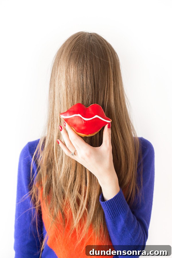 Donut Kiss and Tell: Valentine’s Day Printables & Treat Ideas 10 A woman holding a lip donut