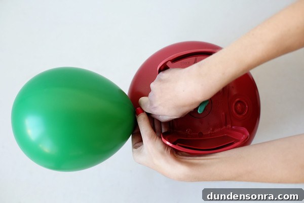 Someone blowing up a balloon