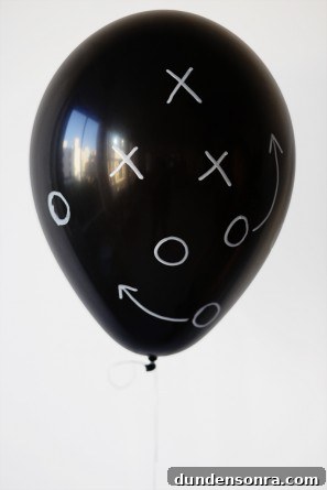 A black balloon with drawings on it