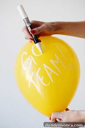 Yellow balloon with white words on it