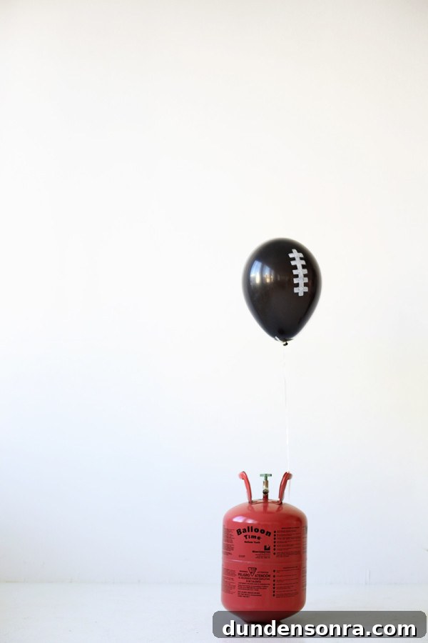 A black balloon with white drawings on it