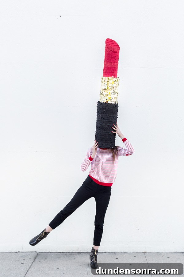 Someone holding a lipstick piñata 