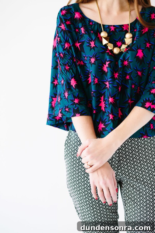 A close up of a woman in a colorful shirt and patterned pants 