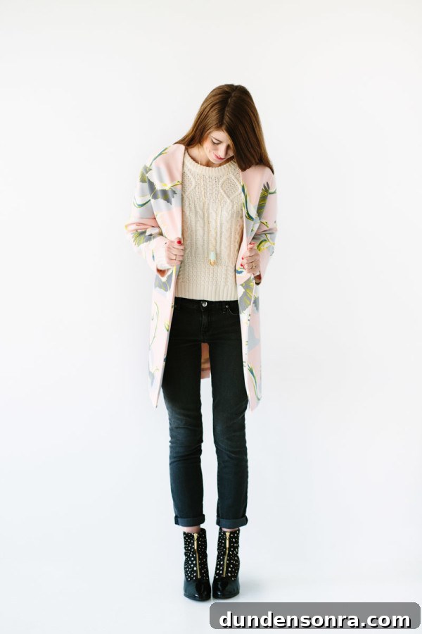 A woman in jeans, a sweater, and a coat
