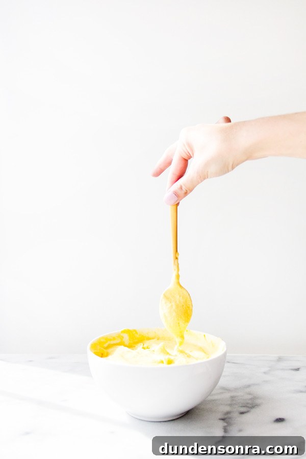 Someone holding a spoon in a bowl
