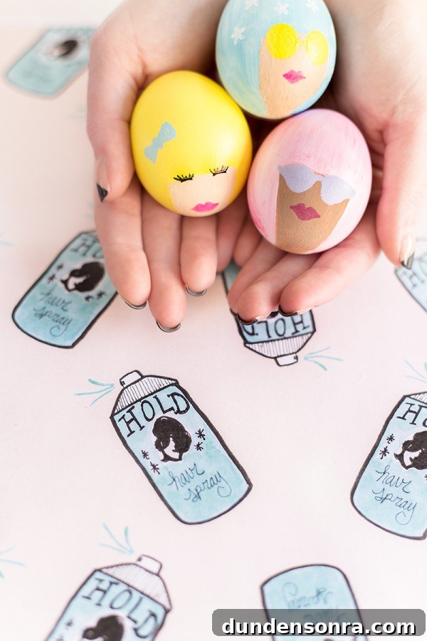 Someone holding eggs with faces painted on them