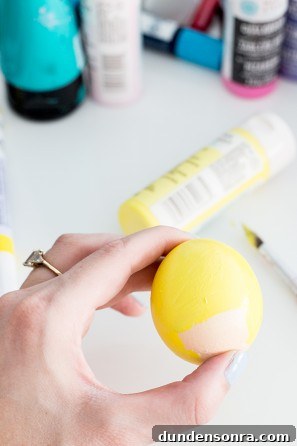 Someone holding a yellow egg