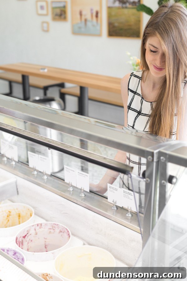 Sugar Fix: Inside Jeni’s Splendid Ice Creams Story 8 A woman looking at an ice cream freezer