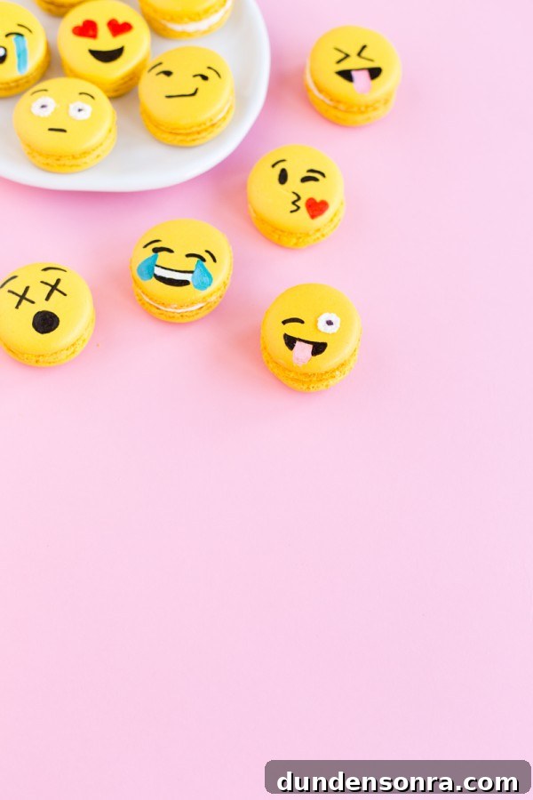 Emoji macarons on a pink background