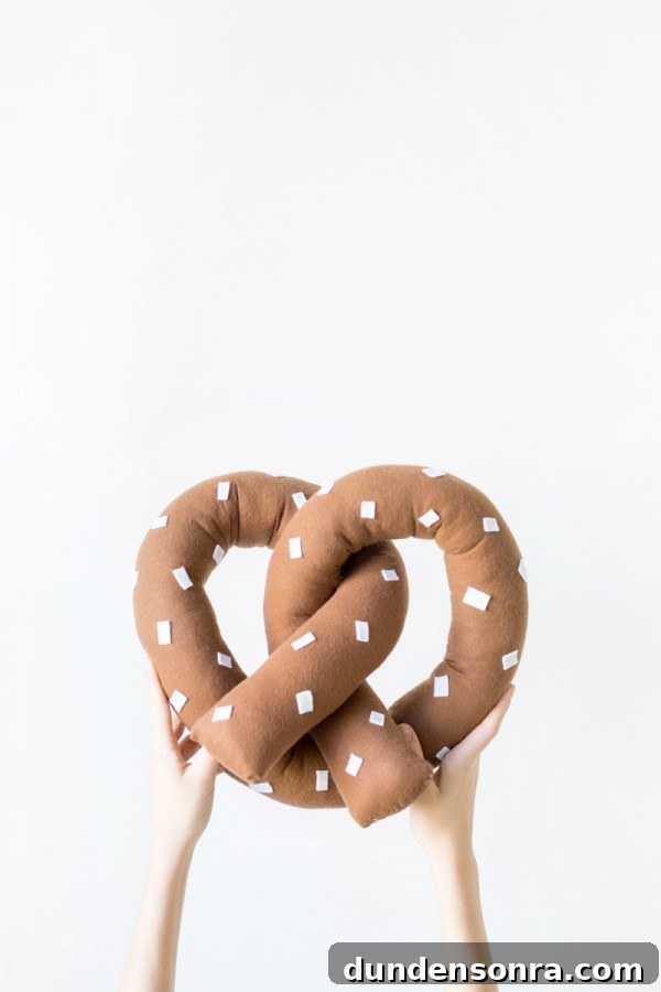 Someone holding a pretzel pillow