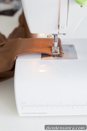Brown fabric being sewn 