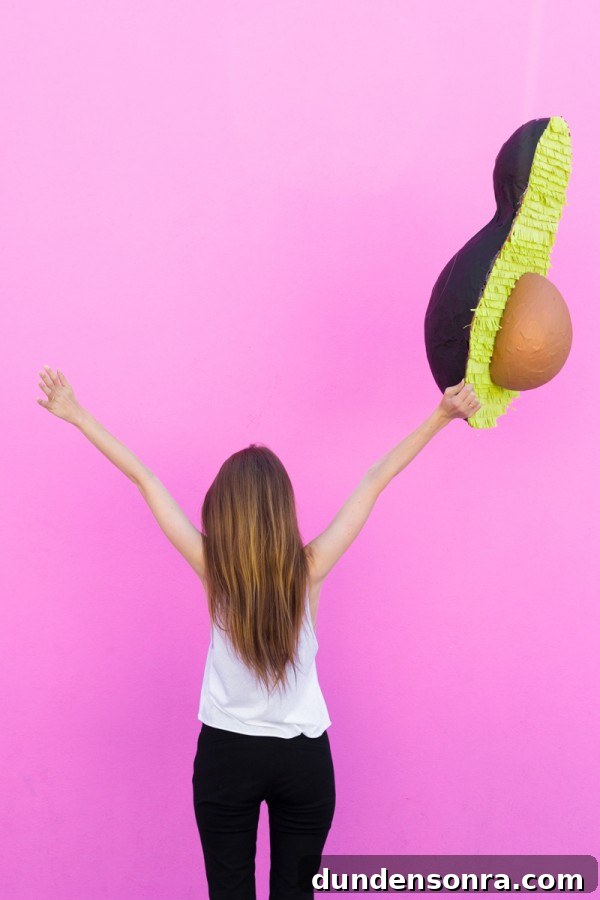 Someone holding an avocado pinata