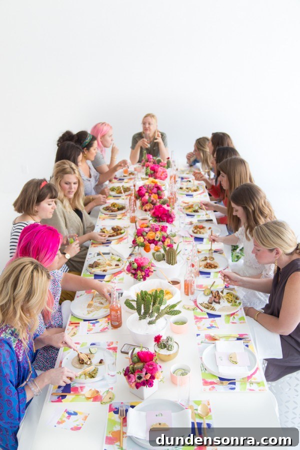 A group of people sitting at a table with a cake