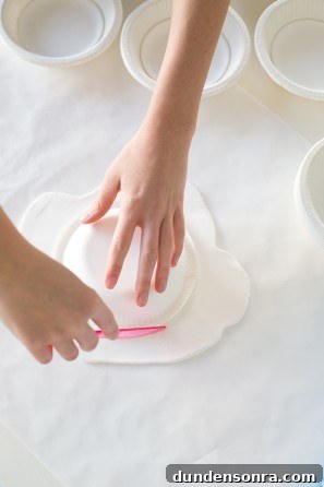 Someone cutting clay