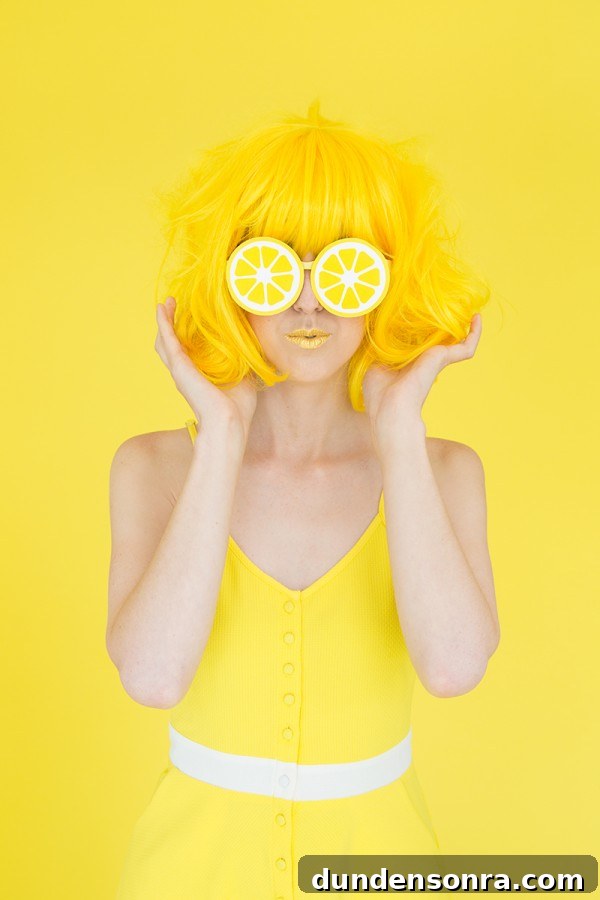 A woman with a yellow wig and lemon glasses
