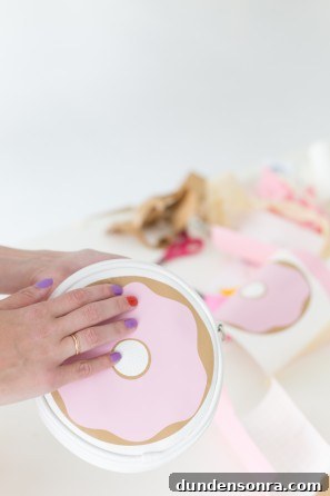 Someone holding a donut case