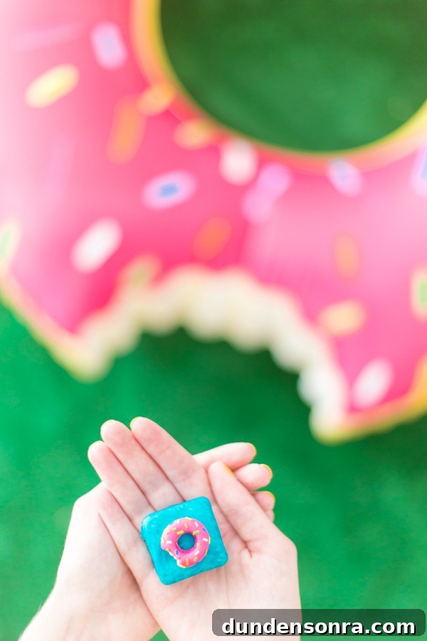 Someones hands and a donut in the background