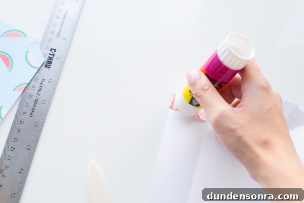 Someone gluing paper